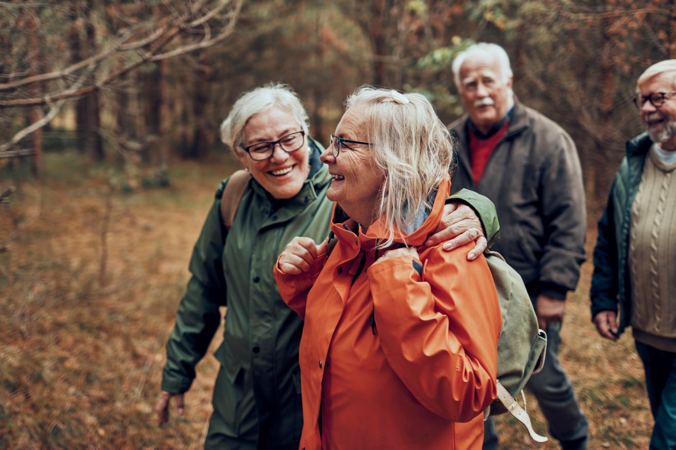 elderly people walking in the woods